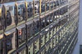 A full wall of gleaming, metallic post office boxes featuring individual locks and numbering. Reflective surfaces in an indoor Royalty Free Stock Photo