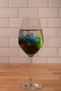 Full wine glass with water and food coloring swirling in glass Royalty Free Stock Photo