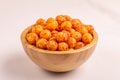 Full wooden bowl of bacon corn puff balls