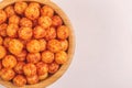 Full wooden bowl of bacon corn puff balls