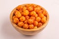 Full wooden bowl of bacon corn puff balls