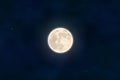 Full yellow moon with star isolated on dark night sky background. Closeup moon light effect. Glow mo