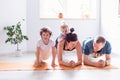 family goes sports at home together. Mom dad baby doing yoga exercises