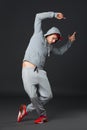 Fullbody portrait of young cool man dancing on dark background. Royalty Free Stock Photo