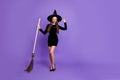 Fulle length photo of charming joyful woman witch conjure hold her broom want fly go to diabolic gathering sorcery magic