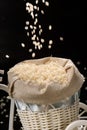 Fulled rice in straw rice bag on black background Royalty Free Stock Photo