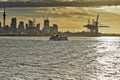 Fullers ferry with city skyline and port cranes in background