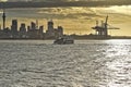 Fullers ferry with city skyline and port cranes in background