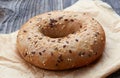 Fullgrain bagel with seeds on wooden table