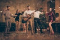 Fulll length photo of funny fellows enjoy music dance celebrate christmas night x-mas party in house with confetti Royalty Free Stock Photo