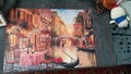 A fully completed jigsaw puzzle block of an image of venice, Italy on a carpet indoors. Activity of solo playing game Indoors