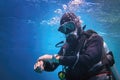 Fully equipped man scuba diver underwater in the blue water