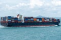 Fully loaded, cargo container ship departing from port of Singapore. Royalty Free Stock Photo