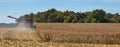 Fully loaded combine harvester waiting for grain cart to unload panorama