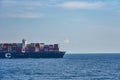 Fully loaded container ship sailing at sea.