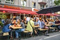 Fully occupied tables and chairs at a street festival. Guests eating and drinking in a restaurant in the center of Berlin