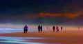 People walking along beach at sunset