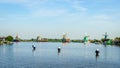 Fully operational historic Dutch Windmills and houses along the Zaan River Royalty Free Stock Photo