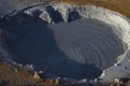 Fumarole fields of Iceland covered with yellow brimstone with boiling mud craters against the winter sky Royalty Free Stock Photo