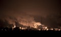 Fuming pipes of a chemical factory , glowing lights of production Royalty Free Stock Photo