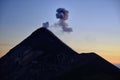 Fuming silhouette of an eruption of active volcano Fuego in Guatemala.