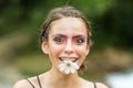 Fummy happy young woman with daisy flower in mouth. Beauty Spring. Springtime. Youth, flowering blossom. Royalty Free Stock Photo
