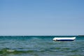 Floating inflatable  white-blue  banana   boat ride  near seashoire Royalty Free Stock Photo