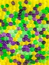 Fun background: many colorful transparent beads swollen in water of the hydrogel lie side by side on a white surface, close Royalty Free Stock Photo