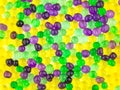 Fun background: many colorful transparent beads swollen in water of the hydrogel lie side by side on a white surface Royalty Free Stock Photo