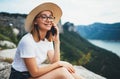 Fun blonde tourist woman in summer hat calling on mobile phone and relax on nature on background landscape, fun young girl travele