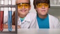 Fun chemistry class - kids giggle in protective glasses