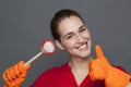 Fun cleaning concept for playful girl holding a dish brush