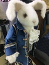 Fun close-up of stuffed Easter bunny on white. White toy rabbit in blue camisole