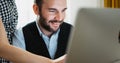 Fun colleague designer discuss startup project. Bearded young businessman working at office. smile director looking in monitor Royalty Free Stock Photo