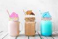 Cotton candy and smores summer milkshakes in mason jar glasses against a white background