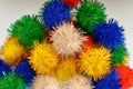 Fun coloured pom poms all in a heap.