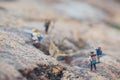 Fun concept of miniature hiker figure adventure in the rocks