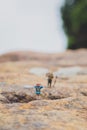 Fun concept of miniature hiker figure adventure in the rocks