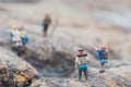 Fun concept of miniature hiker figure adventure in the rocks