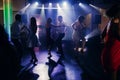 Fun dance party at nightclub after wedding reception, guests and friends dancing on the floor night with lights, disco concept Royalty Free Stock Photo