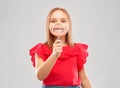 Happy girl with magnifying glass over her teeth Royalty Free Stock Photo