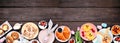 Fun Easter breakfast or brunch bottom border. Top view on a dark wood banner background. Royalty Free Stock Photo