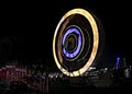 Fun fair Giant Colorful Ferris wheel spinning at night. Slow shutter image of a rotating giant wheel at night Royalty Free Stock Photo