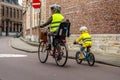 Fun family bike riding with protective gears and fluorescent vests