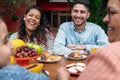 Family laughing and having breakfast outside in the garden Royalty Free Stock Photo