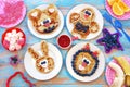 Fun food for children. Set of plates with funny pancakes. Creative idea for kids breakfast. Royalty Free Stock Photo