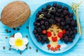 Fun food idea for kids - edible hawaiian girl face from pancake and blackberry, food art Royalty Free Stock Photo