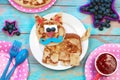 Fun food for kids. Cat shaped pancakes on blue wooden table, top view. Healthy eating. Creative idea for children