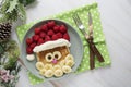Fun food for kids. Christmas Santa pancake with raspberry and banana for children menu, top view with copy space