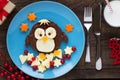 Cute penguin shaped chocolate spread sandwich with fresh fruit for kids